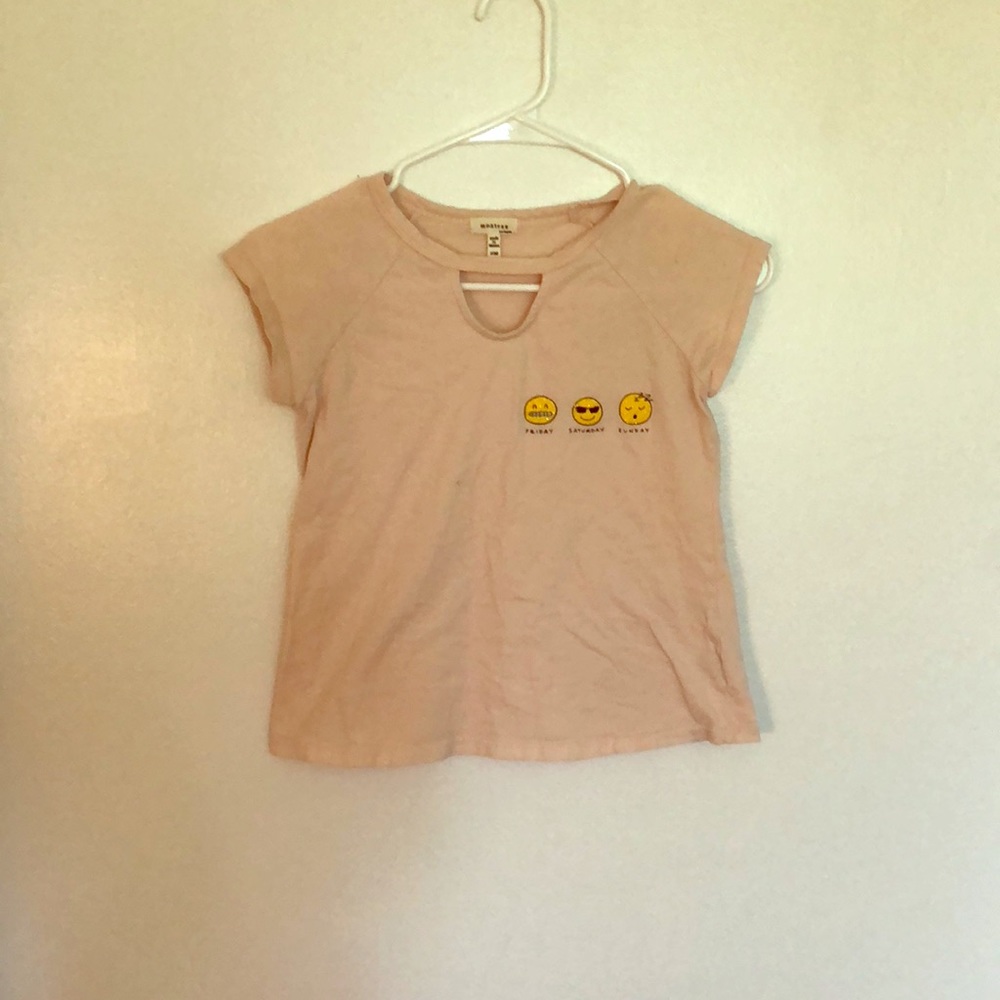 A white pink T-shirt with emoji’s on it